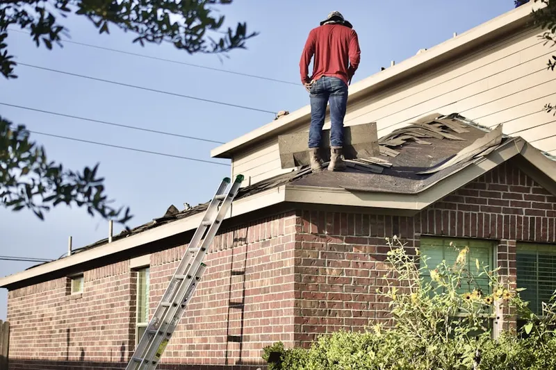 Professional roofer working on a residential roof in Sedge Lake Garden